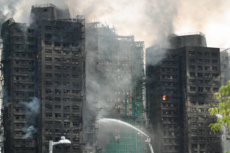 55 dead, hundreds missing in Hong Kong high-rise inferno