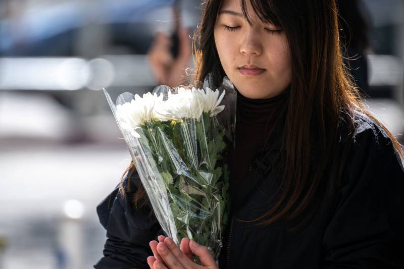 Stunned mourners gather outside ruins of Hong Kong housing estate blaze