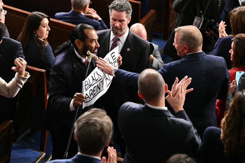 Lawmaker waves 'Black people aren't apes!' sign at Trump address
