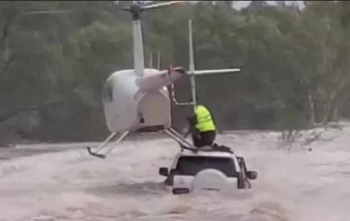 Helicopter rescue saves men, dog from Australian floodwaters