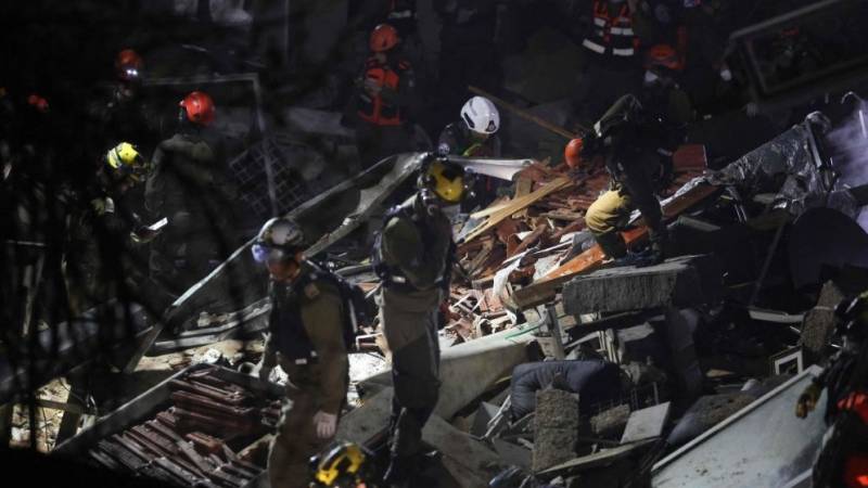 Israeli rescuers search for missing people after buidling hit by Iran missile