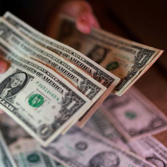 Dollar slides as rate hike prospects ease, oil gains moderate