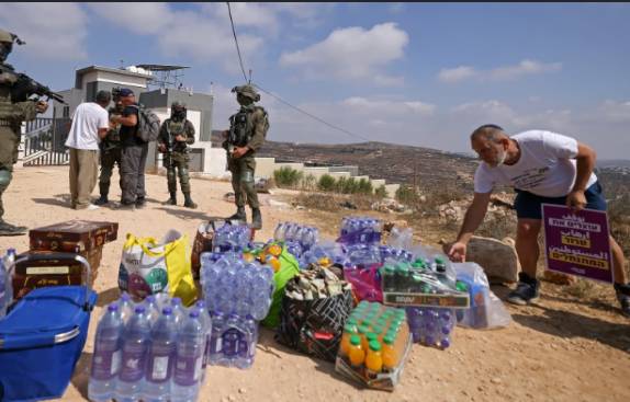 Activists try to get supplies to Palestinians besieged by settlers