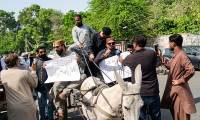 PTI MPAs ride donkey carts to Sindh Assembly to protest fuel hike